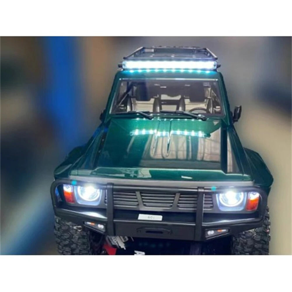Yikong YK4107 Pro 1/10 brushless crawler – front view in water green body showing grille, bumper, LED headlights lit, wide stance