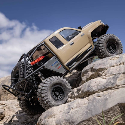 Axial SCX6 Trail Honcho 1/6 RTR crawler in action – beige off-road vehicle climbing rocky terrain
