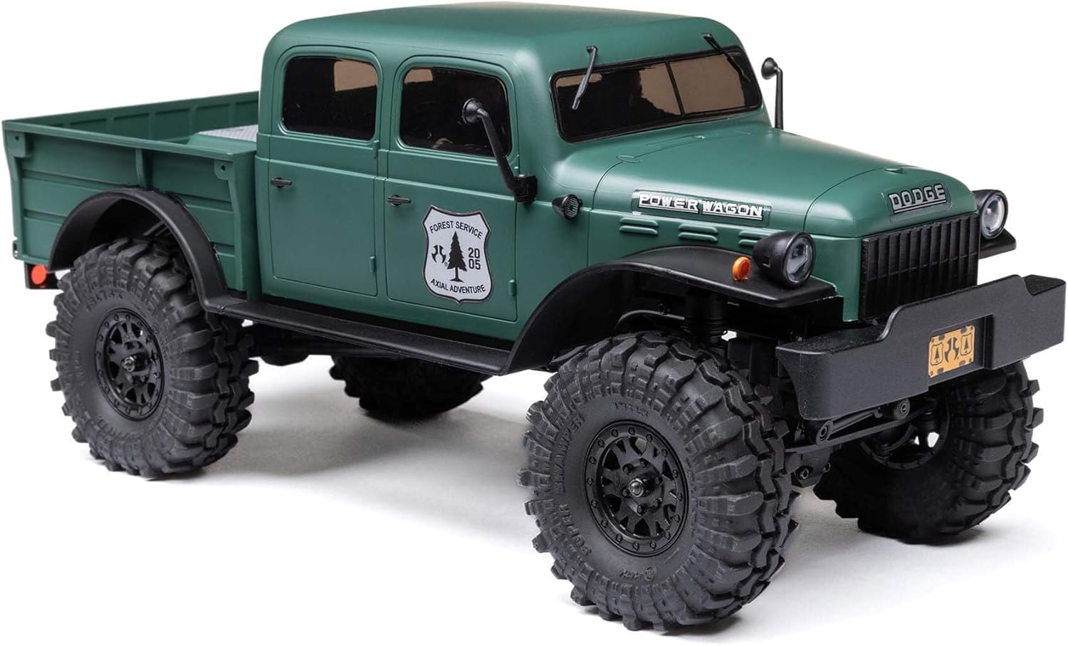 Axial 1/24 SCX24 Power Wagon mini crawler – front 3/4 view displaying green hardbody with detailed cab, bumper, scale accessories, off-road stance