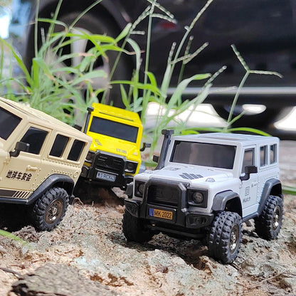 Three Remote controlled LDARC X43 micro crawlers on a sandy surface with grass