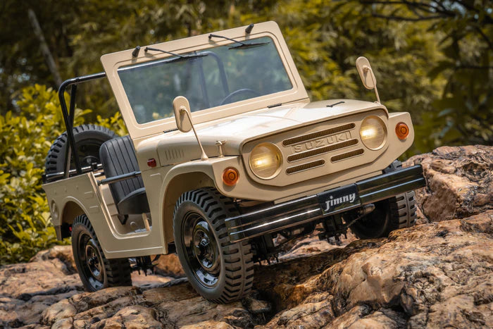1/6 scale Suzuki Jimny 4WD RTR off-road truck in action – climbing rocky terrain with LED lights on