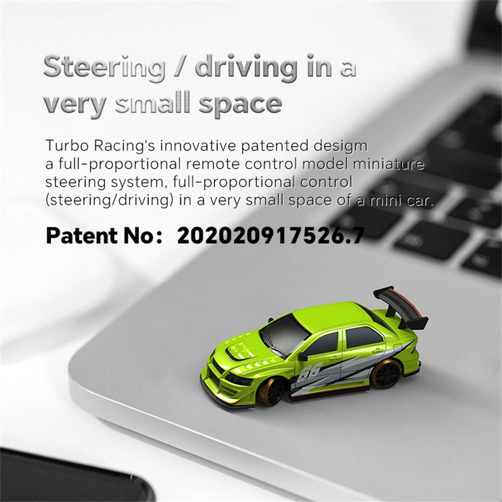 Green Turbo Racing C66 1/76 RC drift car on a laptop keyboard with text about steering and driving in a small space.